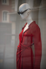 Closeup of red dress on mannequin in a fashion store showroom