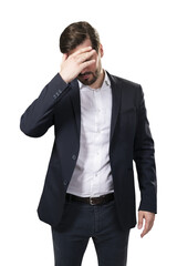 A distraught businessman in a suit covering his face with his hand, isolated on a white background, depicting stress or failure