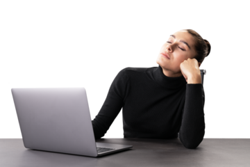 A woman in a black sweater appears tired or stressed at her work desk with a laptop, set against a white background