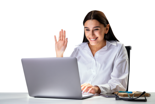 Smiling businesswoman at her desk, waving while using a laptop, isolated on a white background, concept of online work