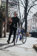 A cheerful man listens to music through headphones while holding a smart phone and standing with his bicycle on a city sidewalk.