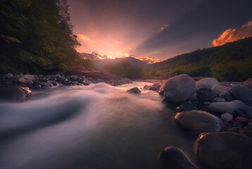 beautiful sunset over fast flowing mountain river