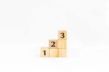1, 2 and 3 number on wooden blocks stairs. Steps towards goal or success.