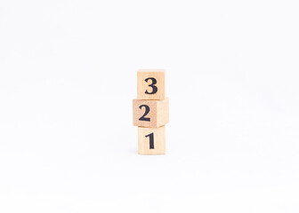 Wooden block numbers tower isolated on white background. Vertical number or ranking concept.