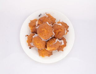 Home baked plain cupcakes in plate on white isolated background. Top view.