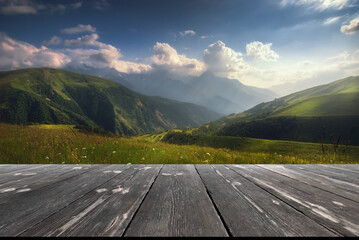 Colorful place in the caucasus mountains. Beautiful outdoor scene with empty wooden table. Natural template landscape - obrazy, fototapety, plakaty