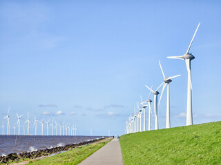 Fototapeta na wymiar offshore windmill park and a blue sky, windmill park in the ocean. Netherlands Europe. windmill turbines in the Noordoostpolder Flevoland