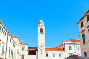 The bell tower of the Church of St. Nicholas in Dubrovnik, Croatia. Clocktower at Luza Square in Dubrovnik  - obrazy, fototapety, plakaty