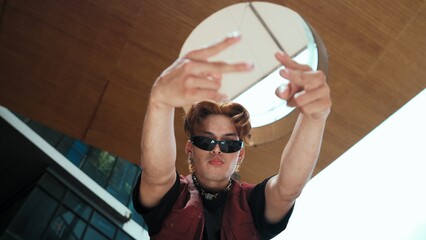 Modern dancer posing at camera with confident with low angle camera. Portrait of young hip hop...