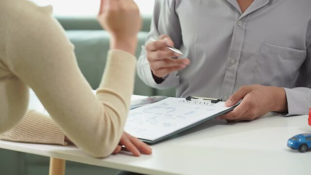 Sales representative, customer, person who signs car insurance or rental documents. Writing your signature on a contract or agreement Buying or selling a new car Car keys on the table. Warranty.
