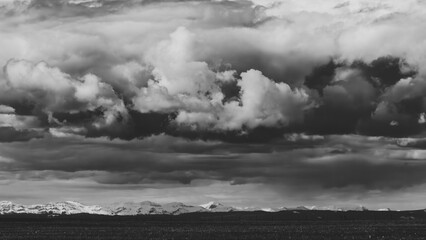 Black and white landscape of storm clouds rolling in over the mountains