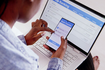 Online Banking On Mobile Phone And Laptop