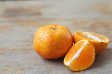 Fresh tangerines with half and slice on a wooden background. 