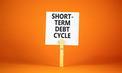 Short-term debt cycle symbol. Concept words Short-term debt cycle on beautiful white paper on clothespin. Beautiful orange background. Business Short-term debt cycle concept. Copy space