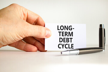 Long-term debt cycle symbol. Concept words Long-term debt cycle on beautiful white paper. Beautiful white background. Businessman hand. Business Long-term debt cycle concept. Copy space.