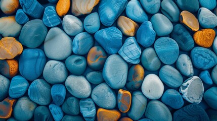 A closeup view of azure pebbles with one electric blue rock in the center