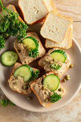 Open sandwiches with pate, cucumber, capers, and parsley. - 783597007