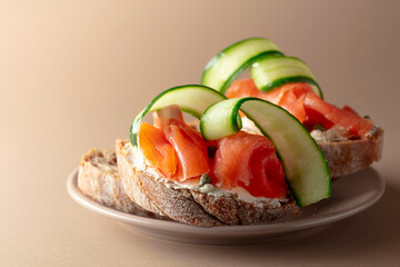 Sandwiches with smoked trout, cream cheese, fresh cucumber and capers.