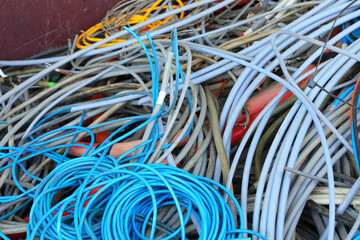 container with coils of old copper and PVC electrical cables for separate waste collection and material recycling in the recycling center - 783597484