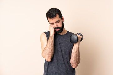 Caucasian sport man with beard making weightlifting over isolated background with tired and bored...