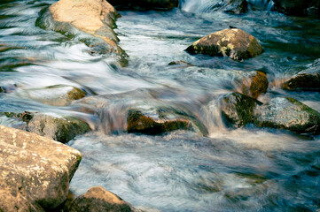 Close up of water flowing through the rocks on the river, shoot in long lens, in Nuandong Valley,...