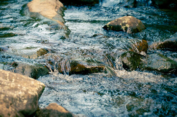 Fototapeta premium Close up of water flowing through the rocks on the river, shoot in long lens, in Nuandong Valley, Keelung city, Taiwan.
