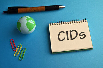 There is notebook with the word CIDs. It is an abbreviation for Climatic impact-drivers as eye-catching image. - obrazy, fototapety, plakaty