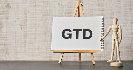 There is notebook with the word GTD. It is an abbreviation for Getting Things Done as eye-catching...