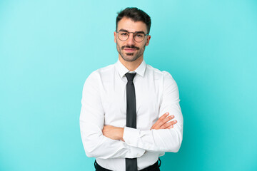 Business caucasian man isolated on blue background keeping the arms crossed in frontal position