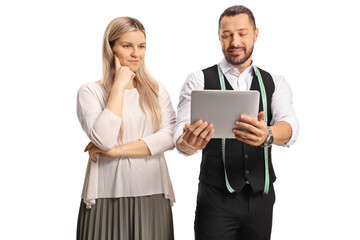 Tailor with a tablet showing designs to a young woman