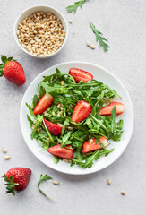 Fresh Strawberry Arugula Salad With Pine Nuts Served on a Bright Day