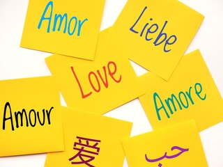 Colorful background with seven yellow sticky notes with the word love written in different languages © MissPic