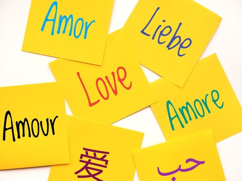Colorful background with seven yellow sticky notes with the word love written in different languages