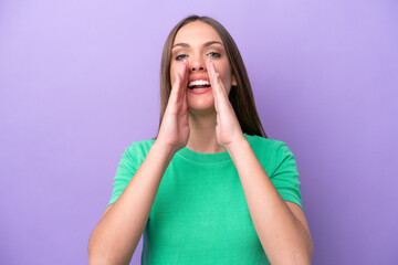 Young caucasian woman isolated on purple background shouting and announcing something