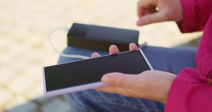 Portable Charger Powering Smartphone Outdoors
