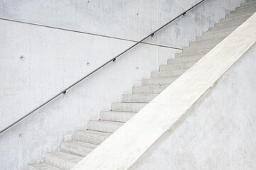 Stone staircase with metal railings in a bright white atmosphere.