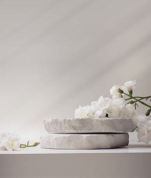 Stone podium for product display with white flowers. Gray showcase mockup