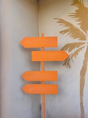 Milestone - orange color wooden signpost with four arrow