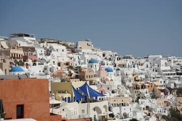 Beautiful scene of the white houses and a church in the daytime in Santorini, Greece