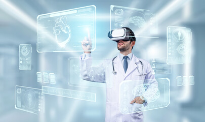 Professional doctor wearing lab coat and VR headset while looking at hologram of human organ....