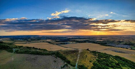 Drone shot of Ivinghoe Beacon sunset with clouds and blue sky
