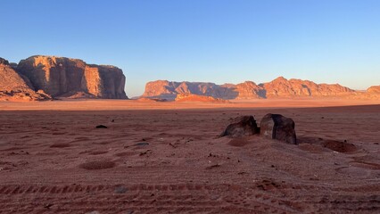 Fototapeta na wymiar Scenic view of the landscape of Wadi Rum desert with tire tracks in Jordan