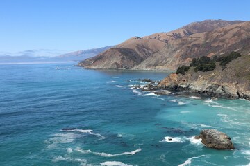 Fototapeta premium Aerial view of the rocky coastline along the Pacific Ocean on the California coast near Big Sur