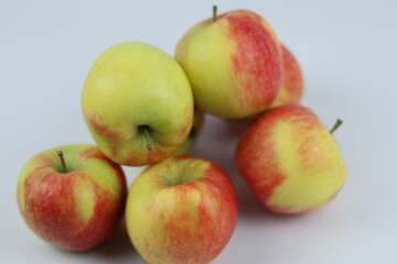 Closeup shot of a group of apples on a white background.