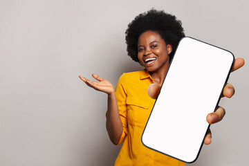 Happy woman holds empty blank screen display phone. Female with smartphone