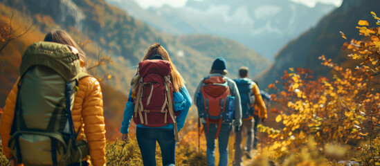 Group of tourists with backpacks hiking in the mountains in autumn.
 - obrazy, fototapety, plakaty
