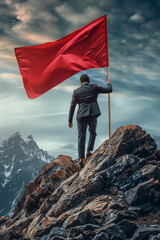 Obraz premium man in a business suit with a red flag climbs on the top of the mountain. concept of success in business, overcoming difficulties.