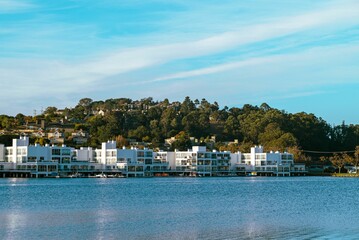 Fototapeta premium Houses on a seashore with a blue sky in the background