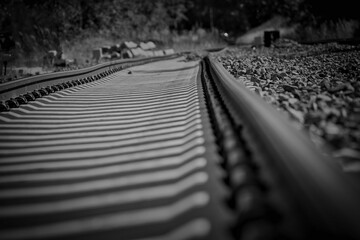 Grayscale shot of an empty railway track