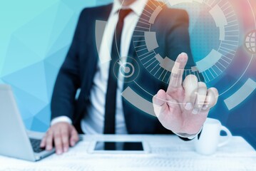 Bussiness Man Sitting Desk Laptop And Phone Pointing Futuristic Technology.
